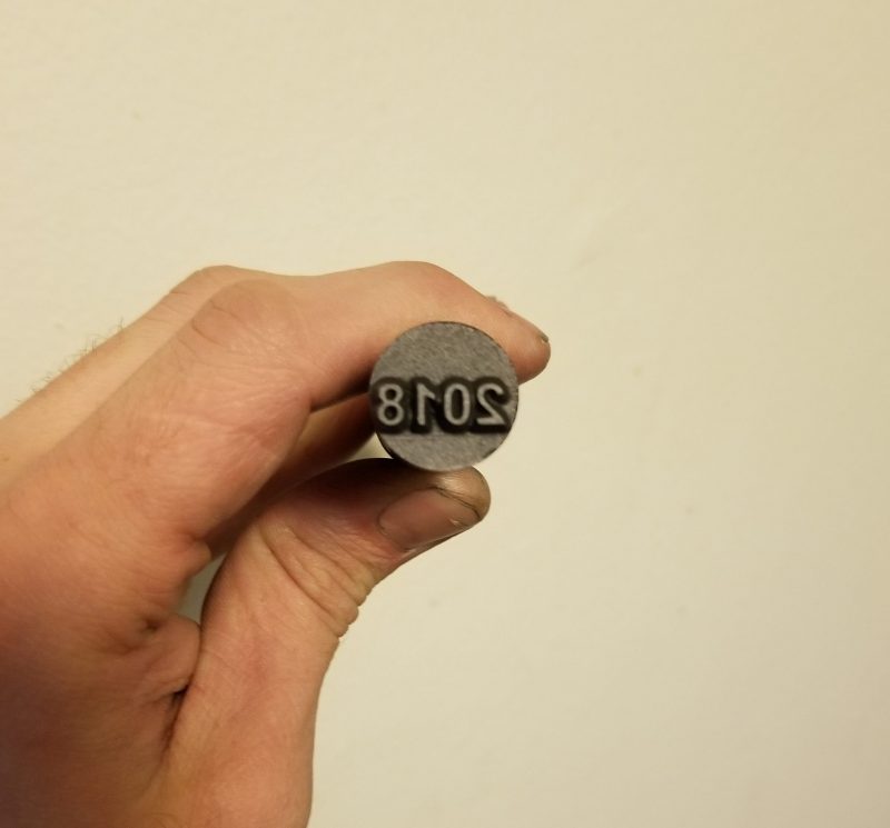This Graphite Stamp Features the numbering 2018